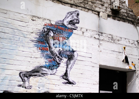 Graffiti au pochoir sur un mur près de Brick Lane, London Banque D'Images