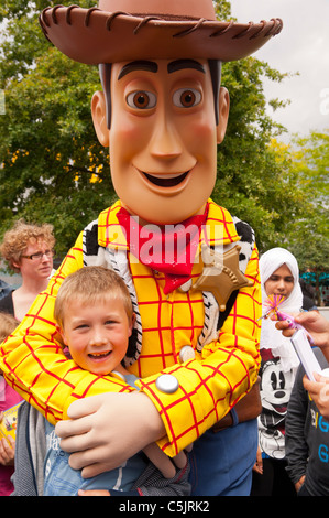 Un garçon de sept ans a sa photo avec Woody Toy Story ( ) de caractère chez Disneyland Paris en France Banque D'Images