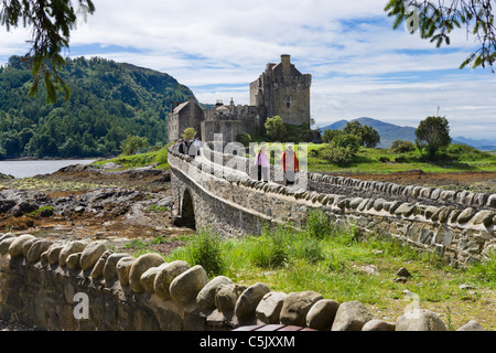 Touristes traversant le pont pour le château d'Eilean Donan, Loch Duich, Highland, Scotland, UK Banque D'Images