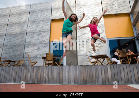 Deux jeunes filles de 8 et 14, sautant hors jeu de café à la nouvelle Galerie Dowse à Lower Hutt, Nouvelle Zélande Banque D'Images