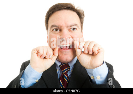 Businessman soie dentaire Les dents avec du fil dentaire. L'hygiène orale libre isolé sur blanc. Banque D'Images