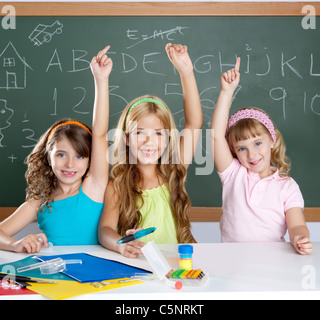 Clever kids groupe d'étudiants à l'école classe raising hand comme enfants intelligents Banque D'Images
