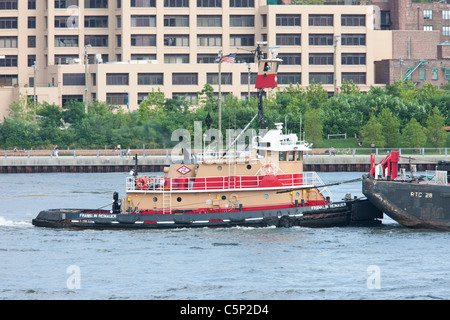 Franklin Reinauer remorqueur poussant une barge sur l'East River passé Pont de Brooklyn Park Banque D'Images