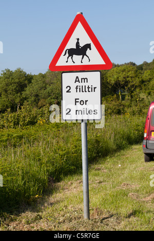 Welsh English avertissement signe multilingue de cavaliers sur la route. Banque D'Images