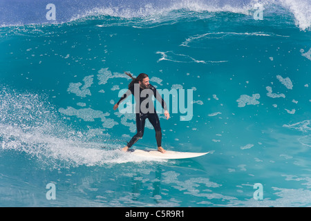 Surfer sourit en rides belle vague bleu azur. Banque D'Images