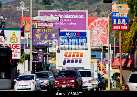 Après-midi, le trafic passe retail enseignes publicitaire à Orange, CA. Banque D'Images