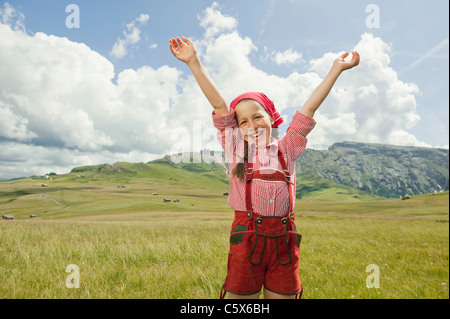 Allemagne, Berlin, Girl (8-9) in meadow, acclamant les bras, portrait Banque D'Images