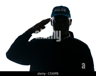 Close-up of an Afro-américain policier saluant en studio sur fond isolé blanc Banque D'Images