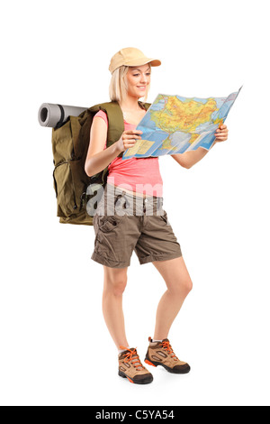 Full Length portrait of female hiker looking at map Banque D'Images