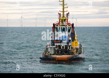 Un remorqueur remorque une barge à l'aide d'un cric pour construire le parc éolien offshore Walney, Cumbria, UK. Banque D'Images