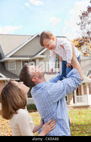 États-unis, Illinois, Metamora, les parents jouant avec baby boy (4-5) in front of house Banque D'Images