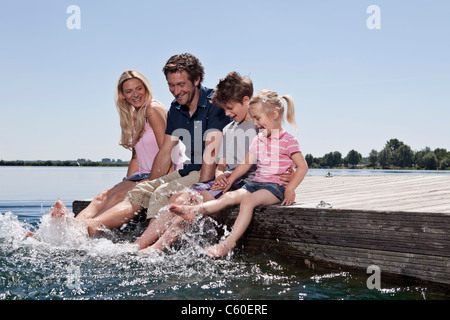 Family playing together on dock Banque D'Images