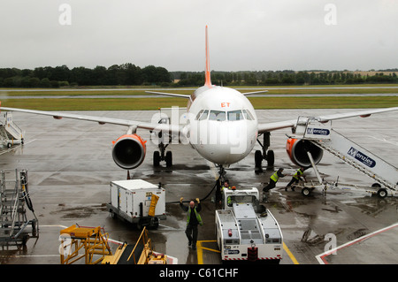 L'appui au sol service à l'aide d'un tracteur pushback pour déplacer un Airbus d'Easyjet sur la voie de circulation à l'aéroport d'Édimbourg en Écosse Banque D'Images