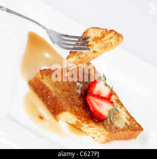 Pain doré au sirop d'égouttement et les fraises sur fond blanc Banque D'Images