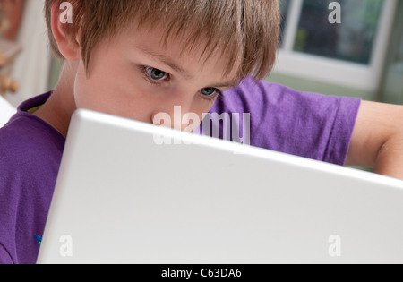 Jeune homme garçon en utilisant son ordinateur portable Banque D'Images
