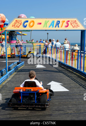 Jeune garçon sur Go Karts sur la jetée de Llandudno Banque D'Images