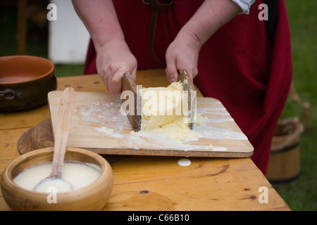 Utilisation des palettes de beurre pour presser et façonner le festival butter maison Medieval à Verdin Park, Northwich août, avec Living History camps, Cheshire, Royaume-Uni Banque D'Images
