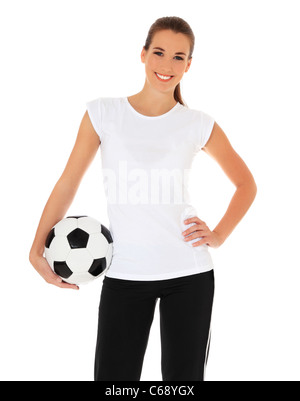 Attractive young woman in sports wear holding soccer ball. Le tout sur fond blanc. Banque D'Images