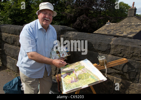 Dez artiste peinture Wilson sa ville de Marsden dans la Colne Valley, West Yorkshire, Royaume-Uni Banque D'Images