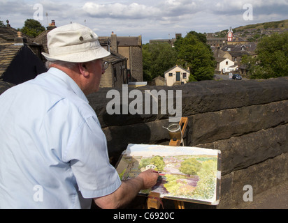 Dez artiste peinture Wilson sa ville de Marsden dans la Colne Valley, West Yorkshire, Royaume-Uni Banque D'Images