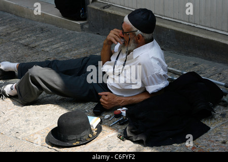 Un sans-abri orthodoxe juif mis en place sur la rue dans le quartier juif de Jérusalem, Israël, demande l'aumône. Banque D'Images