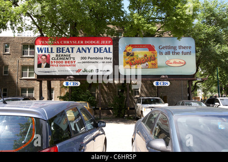 Les affiches publicitaires pour Tim Hortons et un marchand de voiture dans un parking à Winnipeg Manitoba canada Banque D'Images