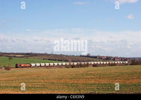 Une locomotive diesel de classe 66 numéro 66192 qui travaille un train de marchandises comprenant des réservoirs de ciment vides se dirige vers le nord le long de la ligne principale de Midland. Banque D'Images