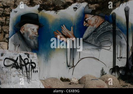 Une peinture murale à Hébron est montrant un colon ultra-orthodoxe juif avec le grand rabbin Ovadia Yossef Banque D'Images