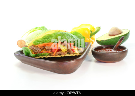 Tacos mexicains avec le boeuf, la laitue, les poivrons et d'avocat sur fond blanc Banque D'Images