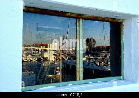 Réflexions dans une fenêtre de navigation des bateaux amarrés dans le port d'Ars en Ré, Charente Maritime nrise ministère, ouest de la France Banque D'Images