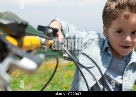 Boy riding bicycle, portrait