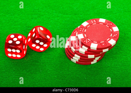 Jetons de casino et de dés rouge sur fond vert Banque D'Images