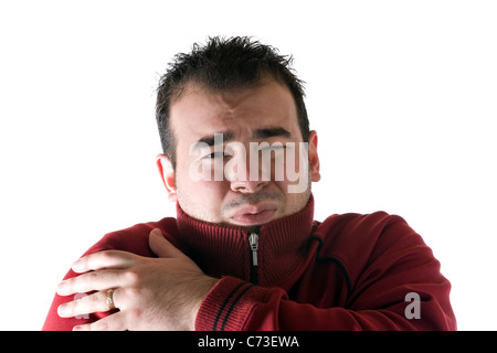 Un homme froid, frissonnant et enfouissant son visage dans son pull. Un concept idéal pour HVAC. Banque D'Images