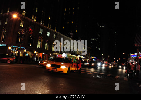 Vue de nuit de la porte arrière qui entre dans un taxi jaune au passage à niveau du chemin piétonnier, 7e Avenue-55th Street, New York City, USA Banque D'Images