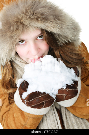 Jeune femme enjouée en hiver manteau à capuchon de fourrure et dégustation holding snow Banque D'Images