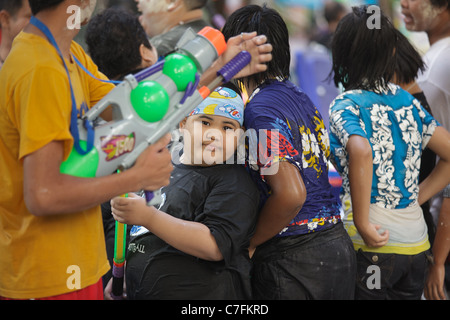 Les thaïlandais une foule fête le nouvel an bouddhiste song kran à Silom Road, Bangkok, Thaïlande Banque D'Images