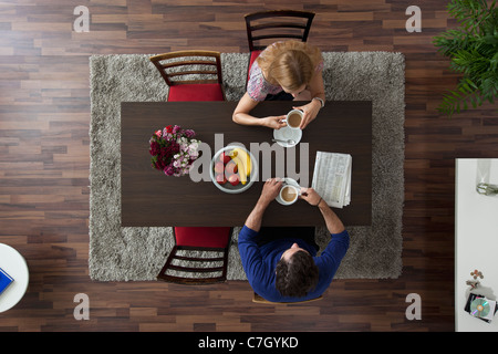 Un couple ayant le café du matin ensemble à une table de salle à manger, overhead view Banque D'Images
