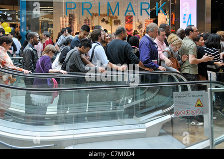 Groupe de personnes sur occupation vers le bas intérieur shopping centre commercial Westfield Mall escalator extérieur Primark magasin de vêtements de Stratford City Newham est de Londres Banque D'Images