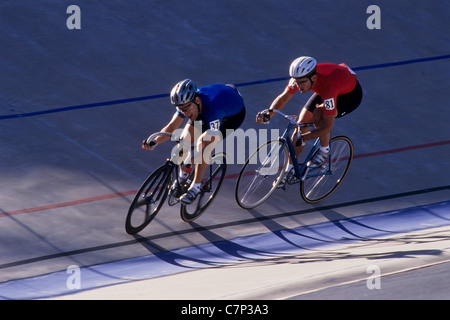 Cycliste masculin en compétition sur la piste du vélodrome. Banque D'Images