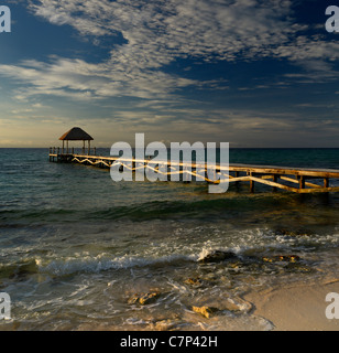 Gazebo au toit de chaume sur le bout d'un quai sur la rive du golfe du Mexique Riviera Maya à l'aube sunrise Banque D'Images