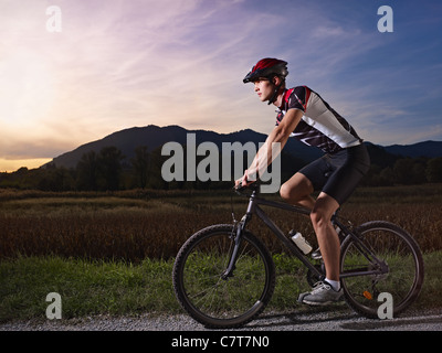 L'activité sportive des jeunes adultes : cyclist riding mountain bike dans la campagne. Vue de côté, de forme horizontale, copy space Banque D'Images