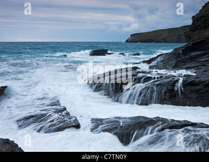 Les vagues de l'Atlantique féroce impact sur les falaises d'ardoise sombre, Trebarwith Strand Cornwall, Angleterre. L'été (juillet) 2011 Banque D'Images