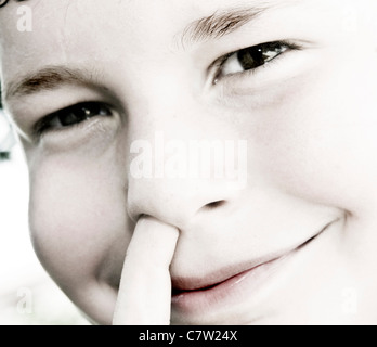 Close-up of a Boy picking son nez Banque D'Images