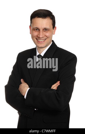 Homme d'affaires en costume noir, smiling, fond blanc Banque D'Images