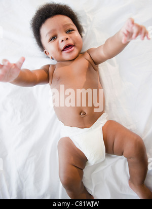 African American baby boy laying on bed Banque D'Images