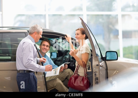 Vendeur montrant outre de car in showroom Banque D'Images