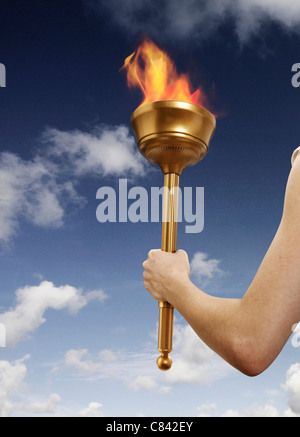 Hand holding flaming baton Banque D'Images