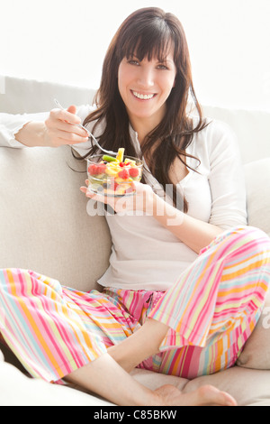 Portrait of Woman Eating Fruit Salad Banque D'Images