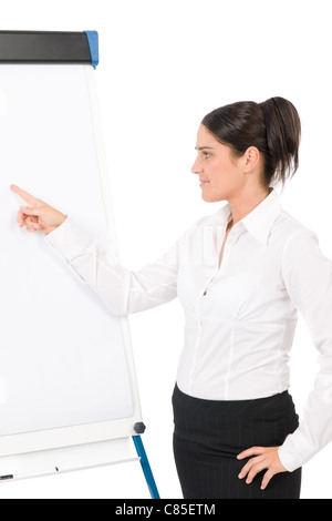 Happy businesswoman pointing at vide tableau on white Banque D'Images