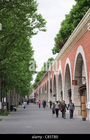 Le Viaduc des Arts, un ancien viaduc de chemin de fer à Paris est maintenant un jardin avec allée dans ses galeries d'arcs. Banque D'Images